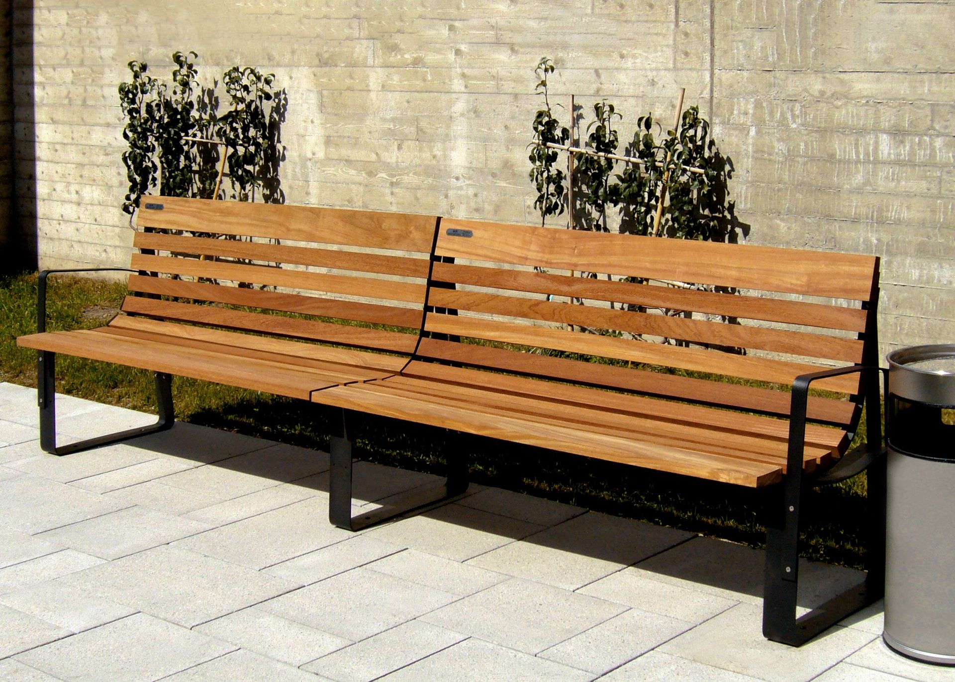 De modulaire Bilateral zitbanken van Urbidermis FSC-gecertificeerde houten zitbank van Urbidermis met stalen frame, voorbeeld van circulair en verantwoord straatmeubilair.