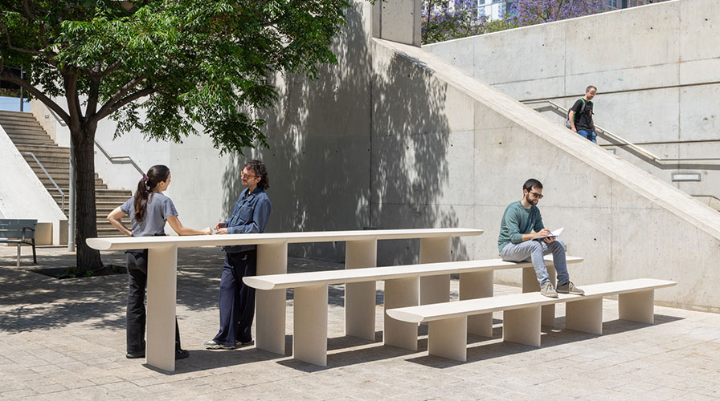 Escofet Tiers avec trois hauteurs d’assise dans un espace urbain ombragé, utilisé pour s’asseoir, lire et discuter.